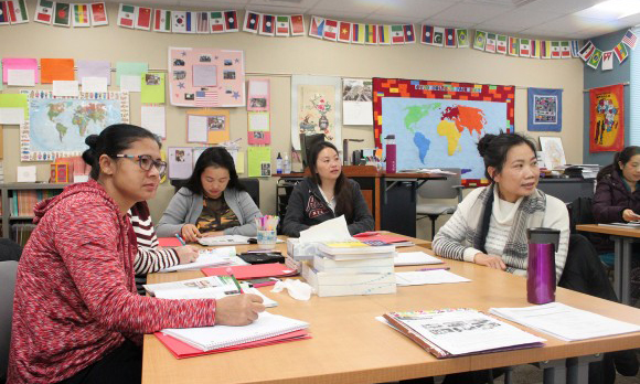 Adult students studying and learning English in a classroom 