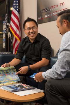 FVTC Veteran Thong Xiong smiling and talking with another student