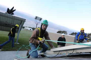 Students installing solar for electrical power distribution at Lakeshore College